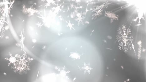 manchas brillantes de luz contra los copos de nieve que caen sobre un fondo gris