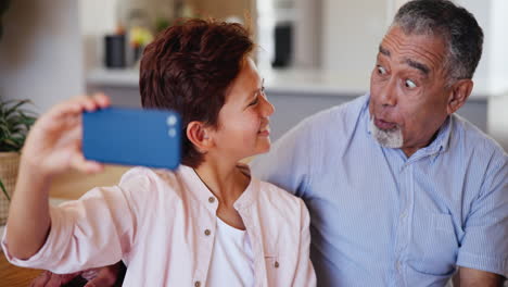 Grandfather,-grandchild-and-smartphone-for-selfie