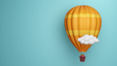 orange and yellow hot air balloon flying among the clouds and carrying a pink gift box with golden ribbons.