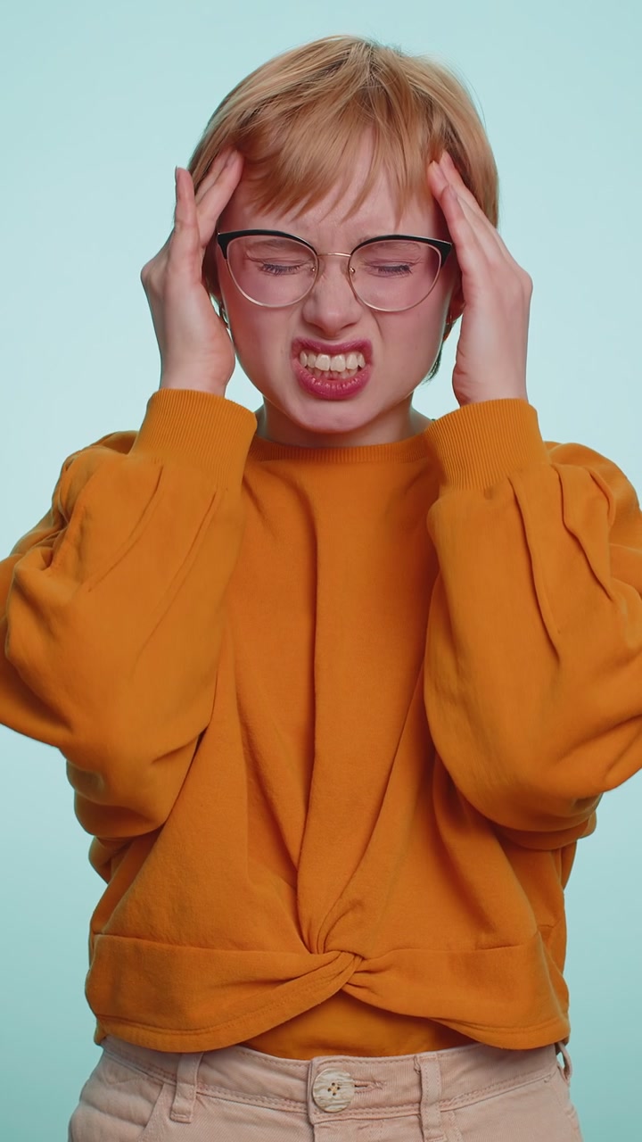 Woman rubbing temples to cure headache problem suffering from tension and migraine stress pain