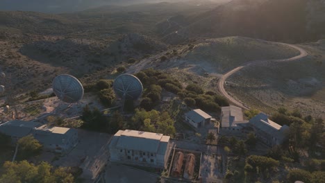 aerial view of mountaintop satellite station at sunset