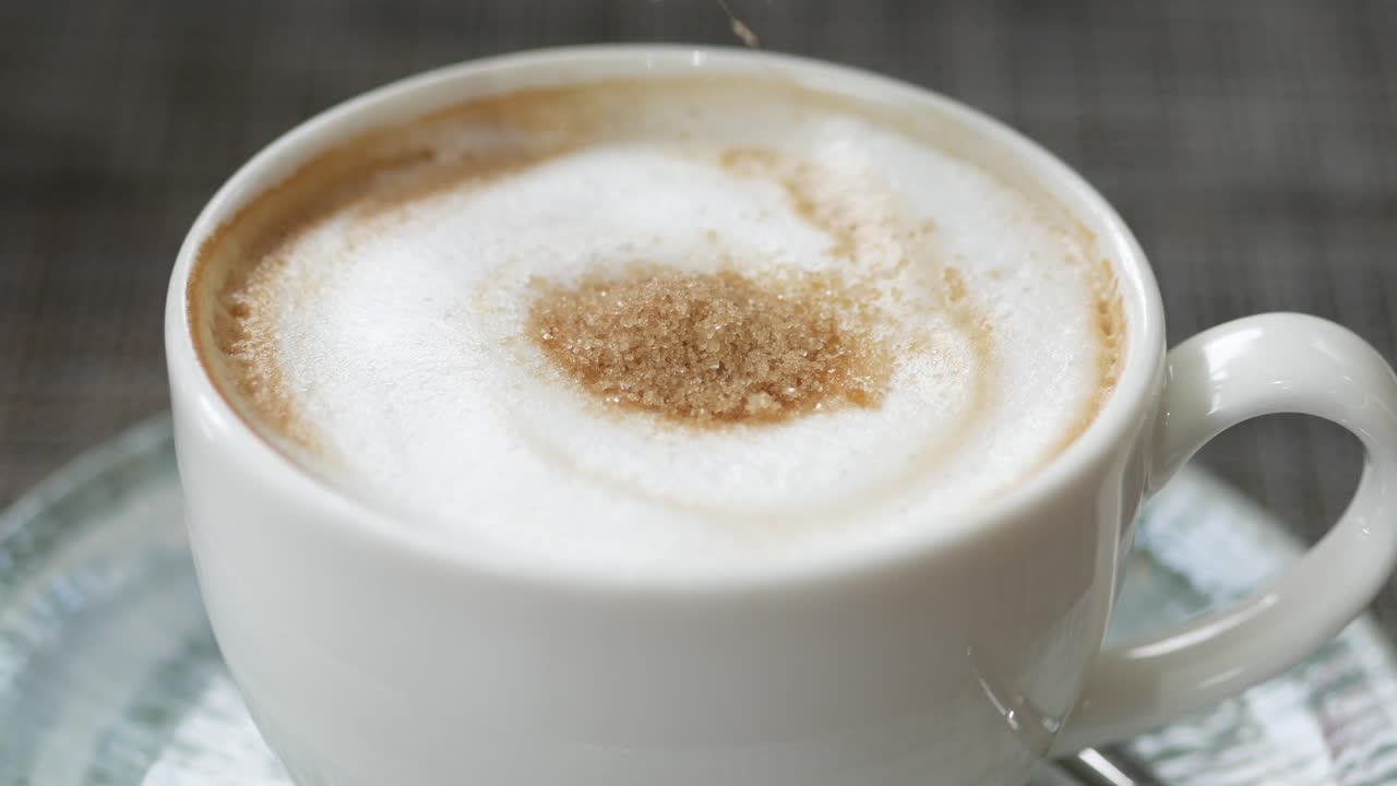 Adding Brown Sugar to a Frothy Coffee