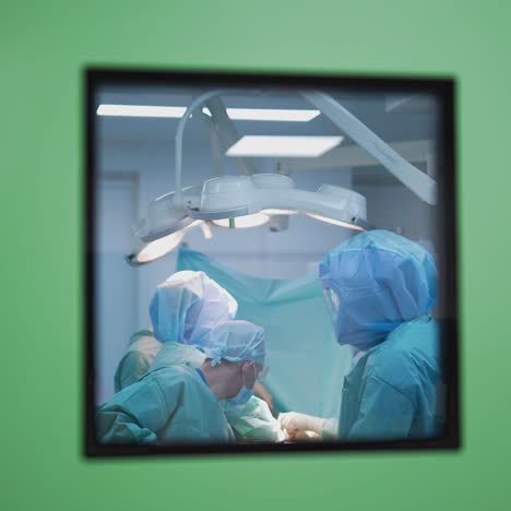 medical team performing surgical operation in bright modern surgery room. operating theatre. modern equipment in clinic