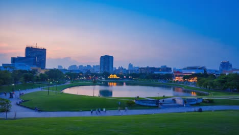 tranquil city park with pond and skyline at dusk