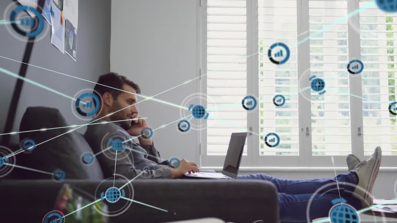 Animation of connected icons, caucasian man sitting on sofa and talking on phone while using laptop