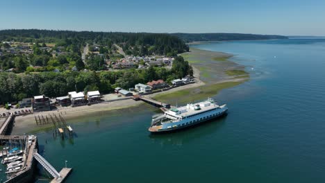 drone shot of a small commuter ferry off the shore of langley, washington