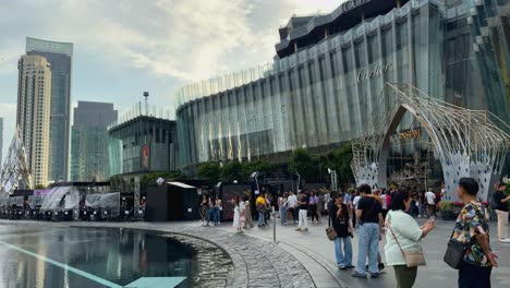 crowds gather outside a modern shopping mall