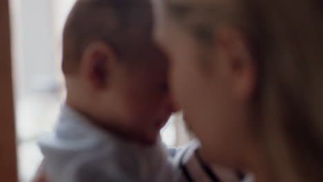 happy young mother playing with baby at home smiling enjoying motherhood