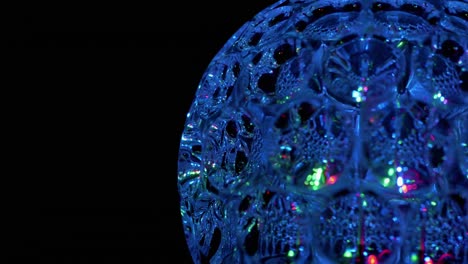 spinning led disco ball glowing neon lights in dark. close-up. 4k