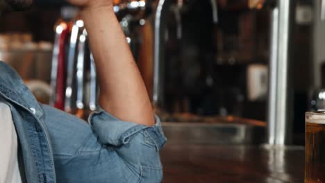 Depressed-man-having-beer-at-bar-counter