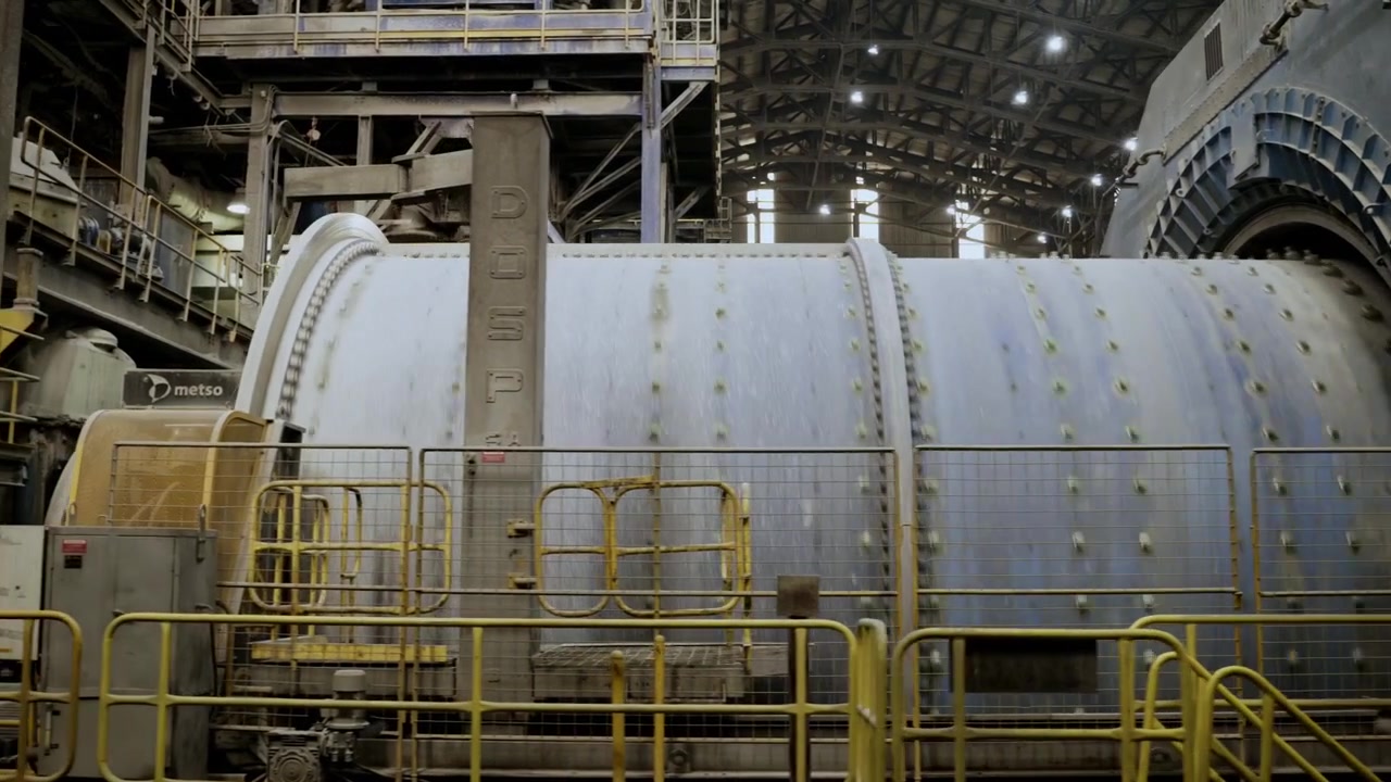 Right to left pan showing an operating SAG mill inside a copper processing facility at El Teniente Mine, Chile. Large-scale mineral processing equipment and industrial mining infrastructure in operati