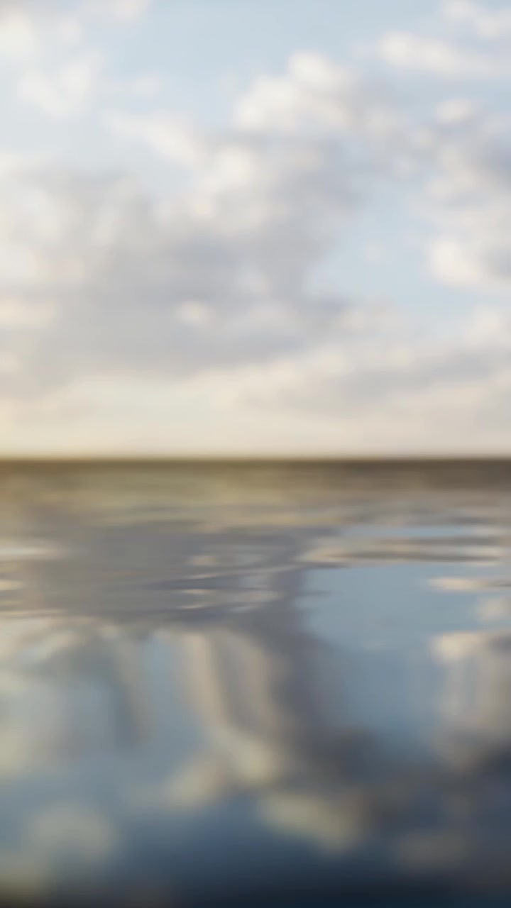 Water surface reflects sky and clouds at sunset over a lake
