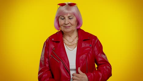 Mujer-Mayor-Alegre-Y-Elegante-Con-Cabello-Rosado-Y-Chaqueta-De-Cuero-Roja-Sonriendo-Y-Mirando-A-La-Cámara