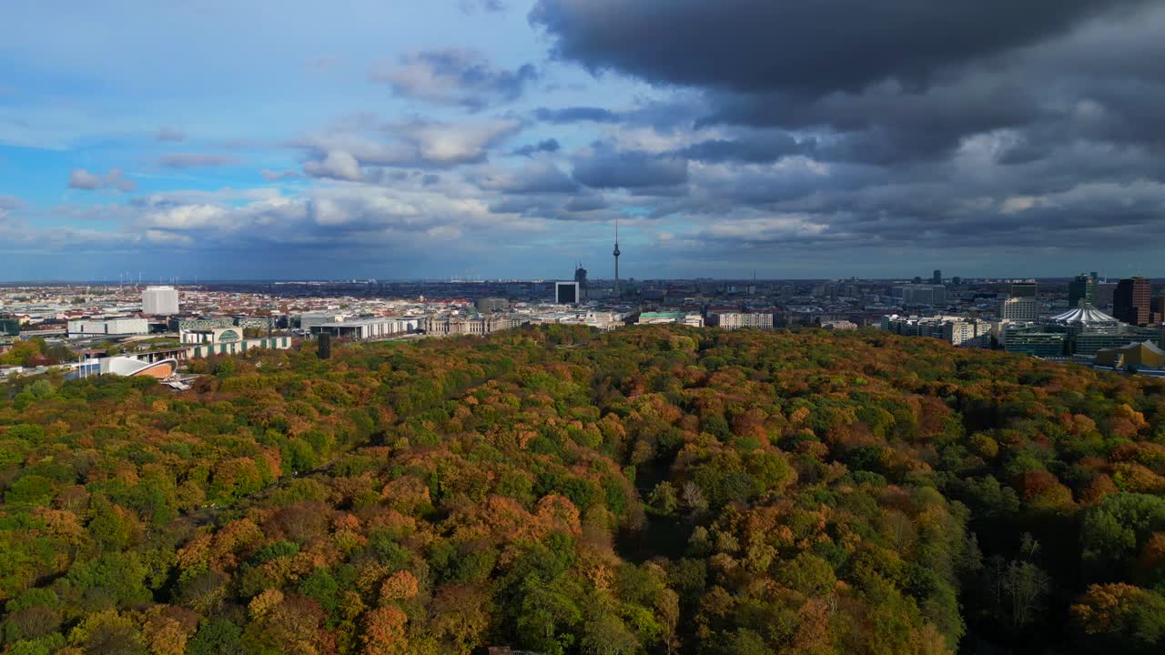 Berlin cityscape from Tiergarten park to Reichstag, Brandenburg Gate and Tv Tower. Stunning aerial view flight descending drone