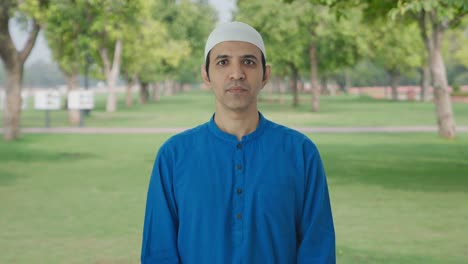 Serious-Muslim-man-looking-to-the-camera-in-park
