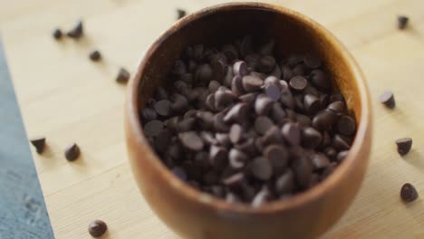 Video-of-close-up-of-bowl-with-organic-chocolate-chip-on-wooden-background