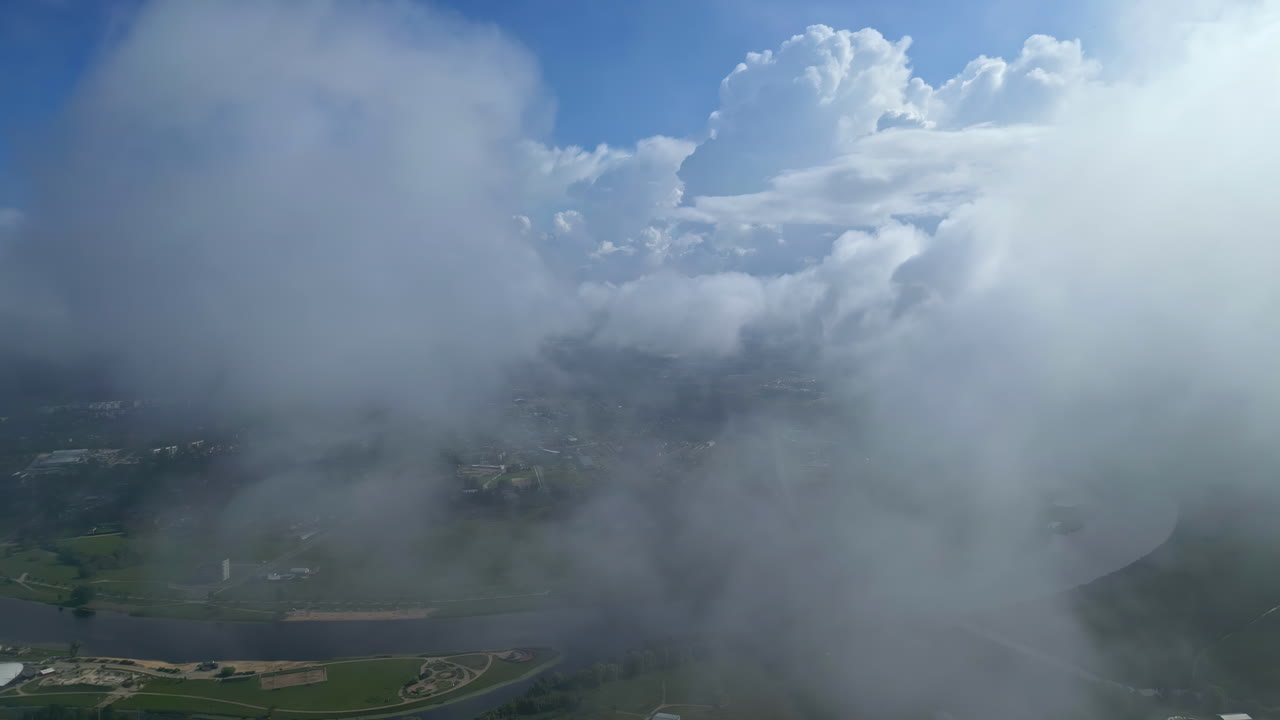 Misty Clouds Reveals Flowing River On Countryside Town At Sunrise.