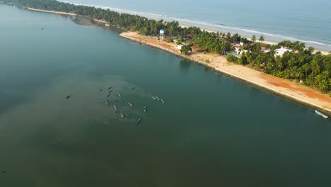 aerial drone shot of a coastal island village with coconut trees in udupi