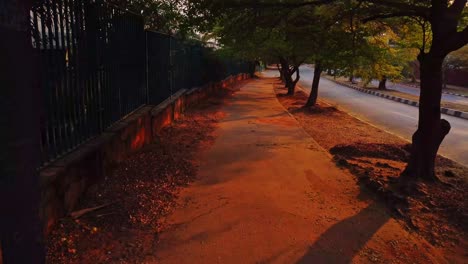 walking over a pedestrian sidewalk next to a calm road with a single driving road in abuja, the capital of nigeria