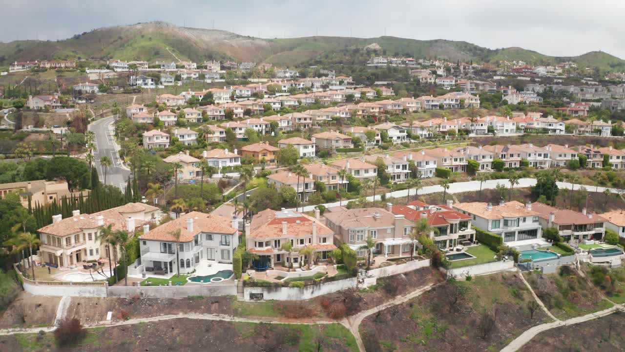 Aerial wide dolly shot of The Summit residential development in Palisades Highlands after the Palisades Fire in Los Angeles, California. 4K
