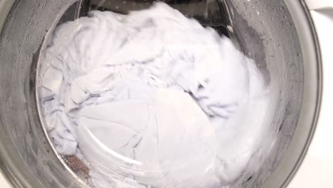 closeup washing machine washes dirty colorful clothes closeup washing machine washes dirty colorful clothes washing clothes in a washing machine video