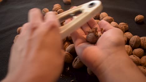 Young man is cracking some fresh dried walnuts-5