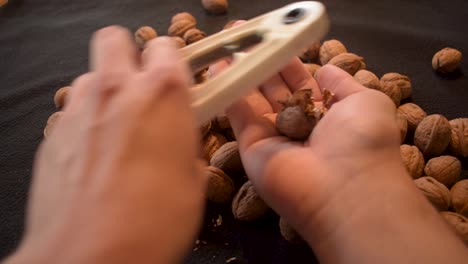 young man is cracking some fresh dried walnuts-5