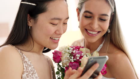 two bridesmaids looking at a phone