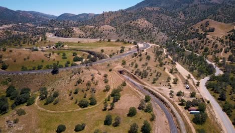 railroad tracks and tunnel at tehachapi loop or pass in california, aerial push