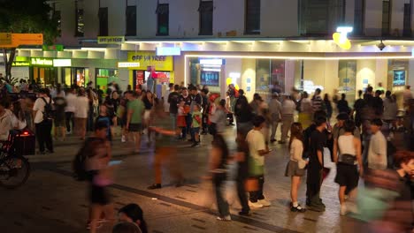 vibrant nightlife of brisbane city, a bustling downtown with massive crowds of people paced in queen street mall, showcasing the influx of population, fast time-lapse motion shot.