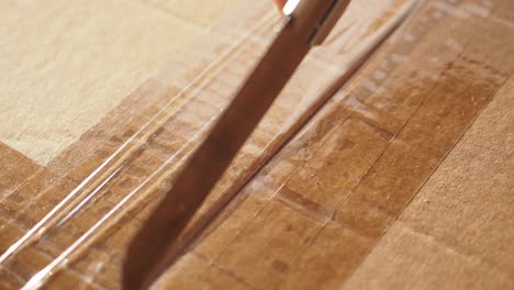 cutting tape from a cardboard box