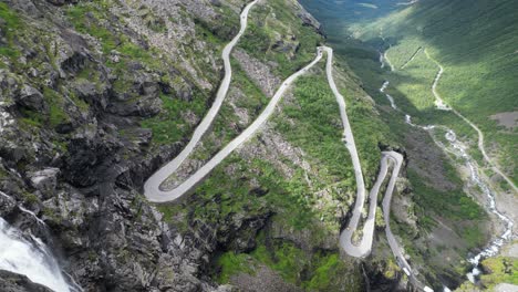 Trollstigen-Mountain-Pass,-Norway---Scenic-Route-with-Waterfall-and-Hairpin-Turns-in-Romsdalen-Valley---Pan-Right