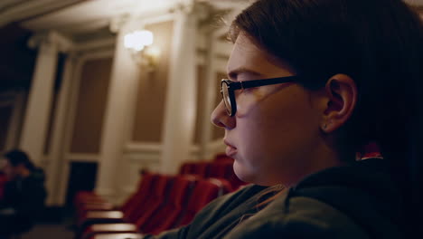 empty theater and a woman watching
