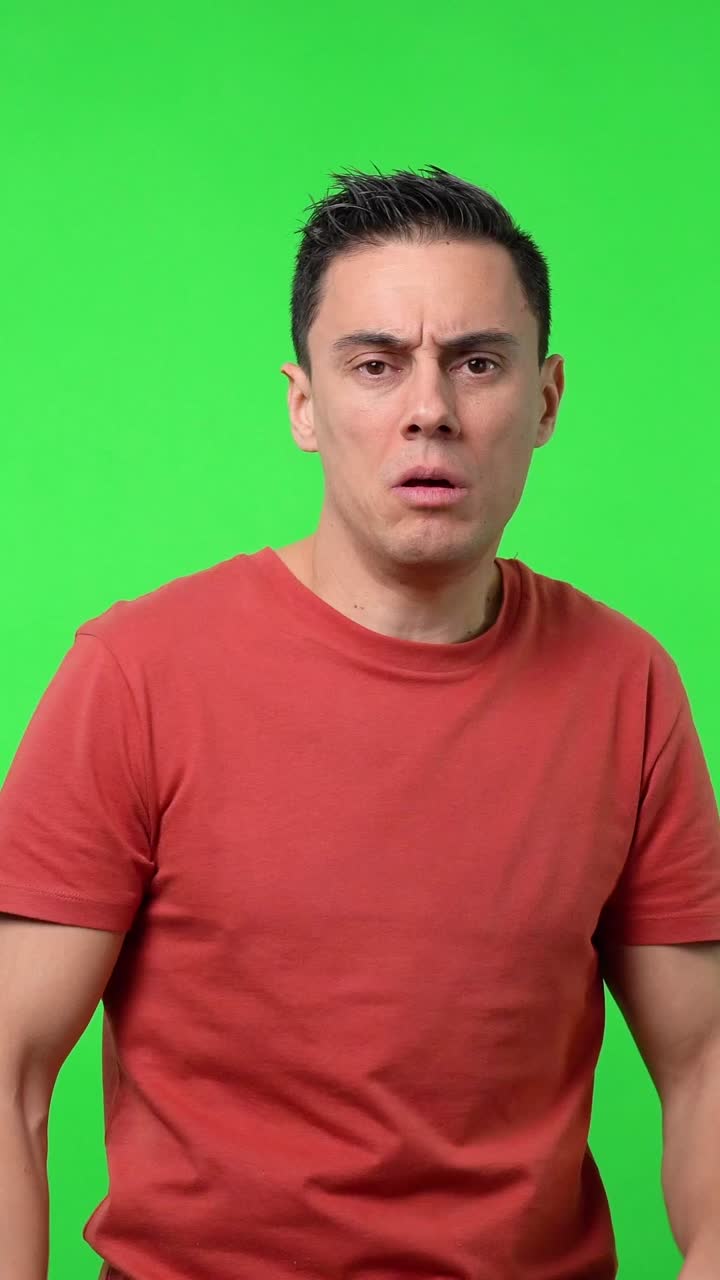 Man expressing negative emotions on green screen