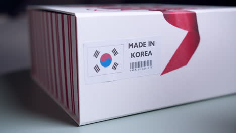 제품이 들어 있는 배송용 판지 상자에 한국 국기 라벨을 붙인 손