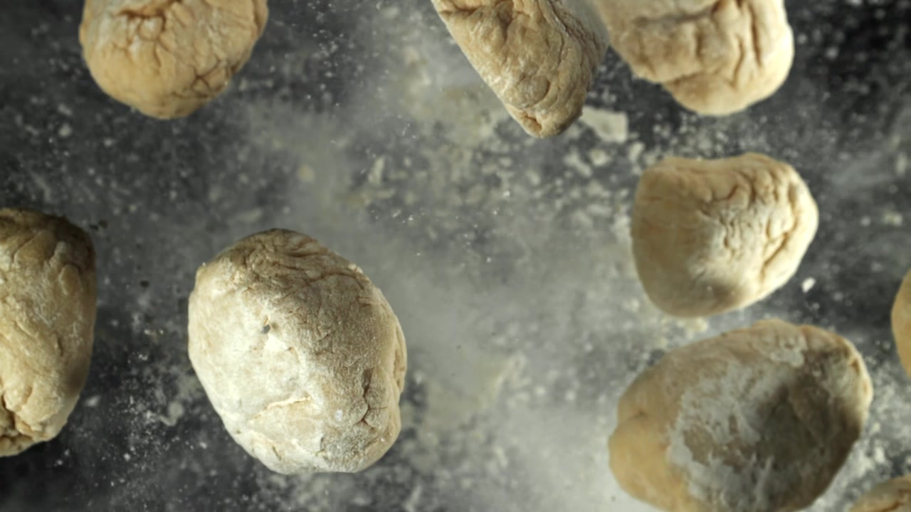 Slow Motion of Dough Pieces Falling with Flour Dust