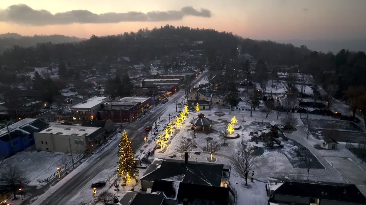 aerial orbit of blowing rock nc, north carolina in snow at sunrise
