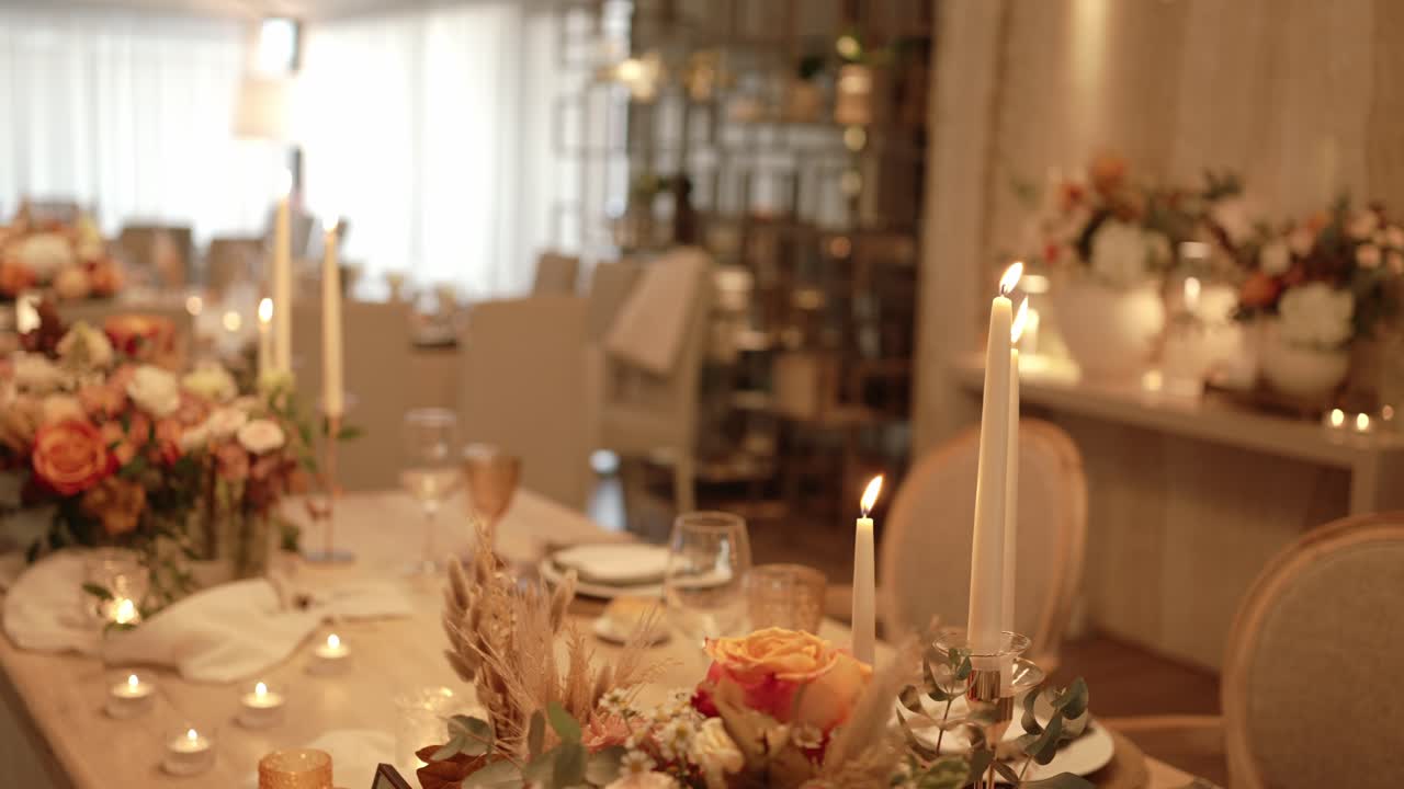 Elegant wedding table with flowers and candles at evening dinner