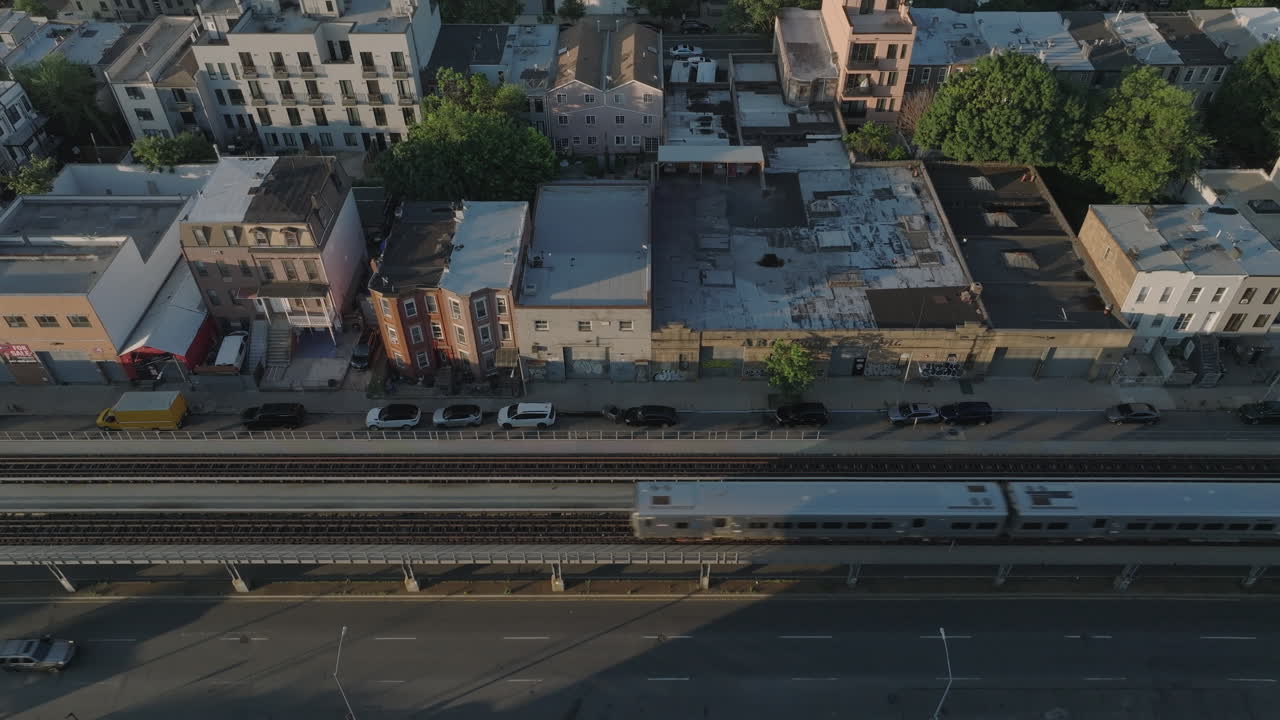 Aerial view of the Long Island Railroad at sunrise. Shot in Brooklyn on a summer morning