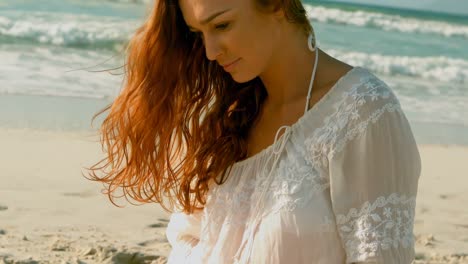 Caucasian-woman-relaxing-on-beach-in-the-sunshine-4k