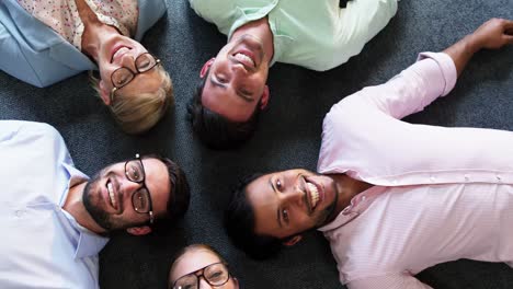 portrait of businesspeople lying on the floor