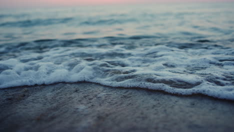 Sea-waves-breaking-sand-beach-on-evening-seashore-sunset-dawn.-Nature-relax
