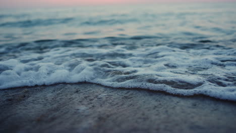 sea waves breaking sand beach on evening seashore sunset dawn. nature relax