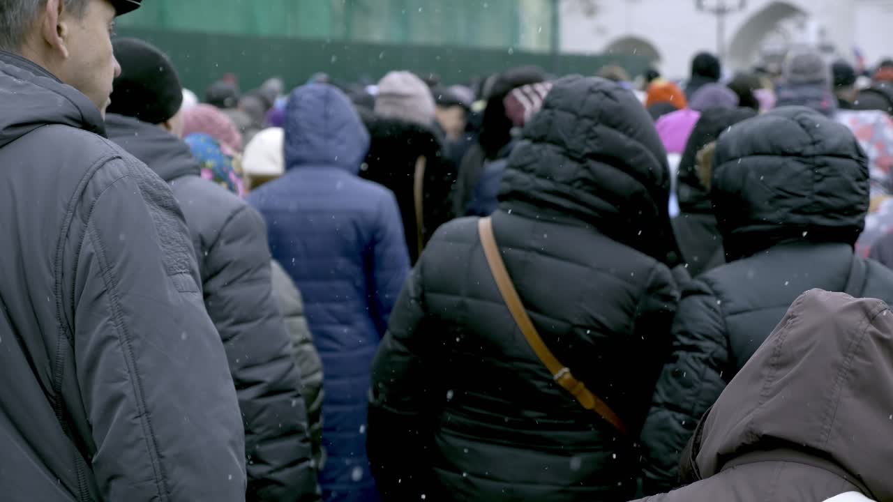 Large Crowd Walking in Snowy Conditions