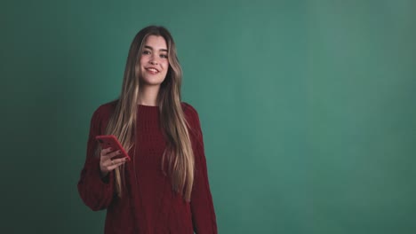 woman holding a mobile while pointing aside