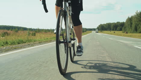 female triathlete in helmet cycling on road