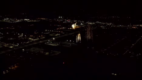 aerial shot of fireworks with city lights in the background.  city night lights.  4k footage.