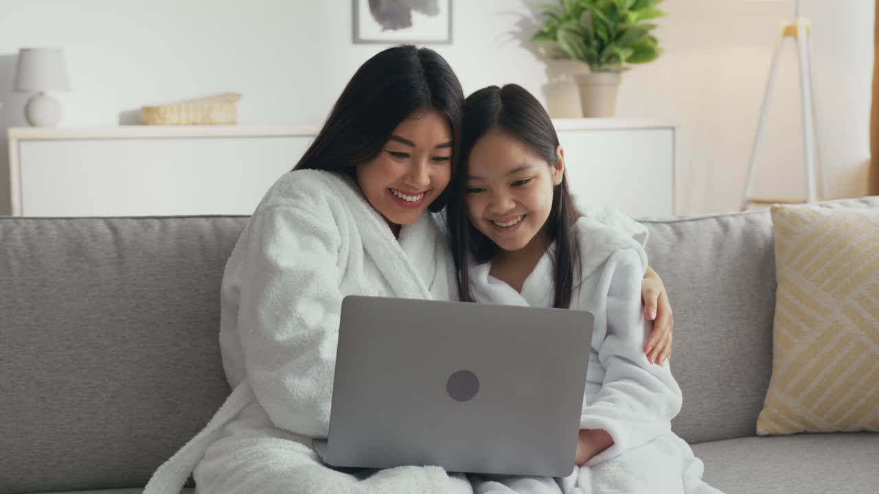 Mother and Daughter Enjoying Time Together on a Laptop