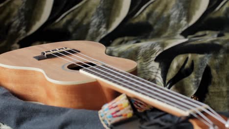 ukulele small guitar close up. follow focus