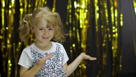 Child-dancing,-enjoying-music,-moving-in-slow-rhythm-dance.-Girl-4-5-years-old-in-shiny-t-shirt